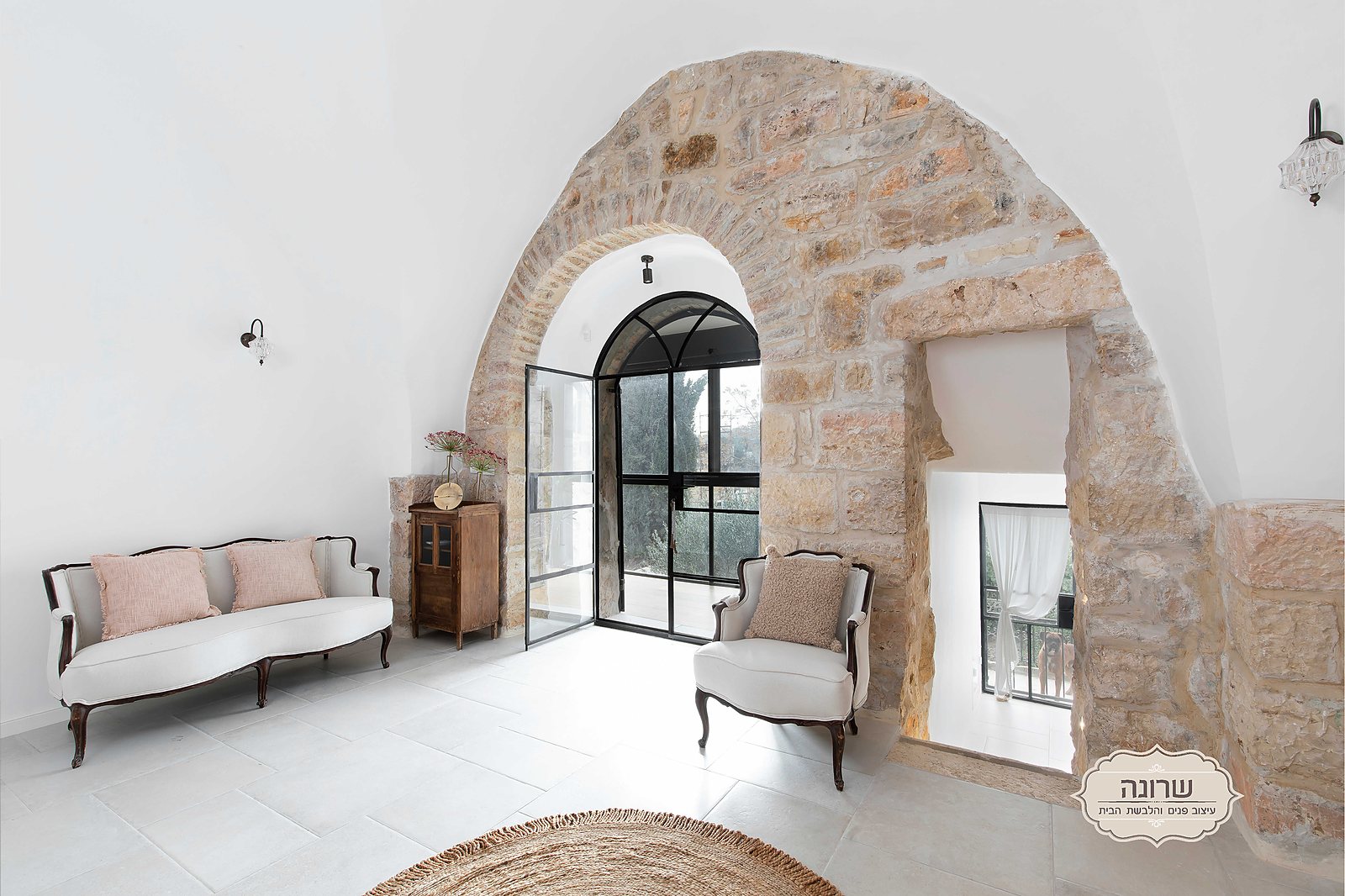 Living room under original stone arches in a heritage house in Ein Karem