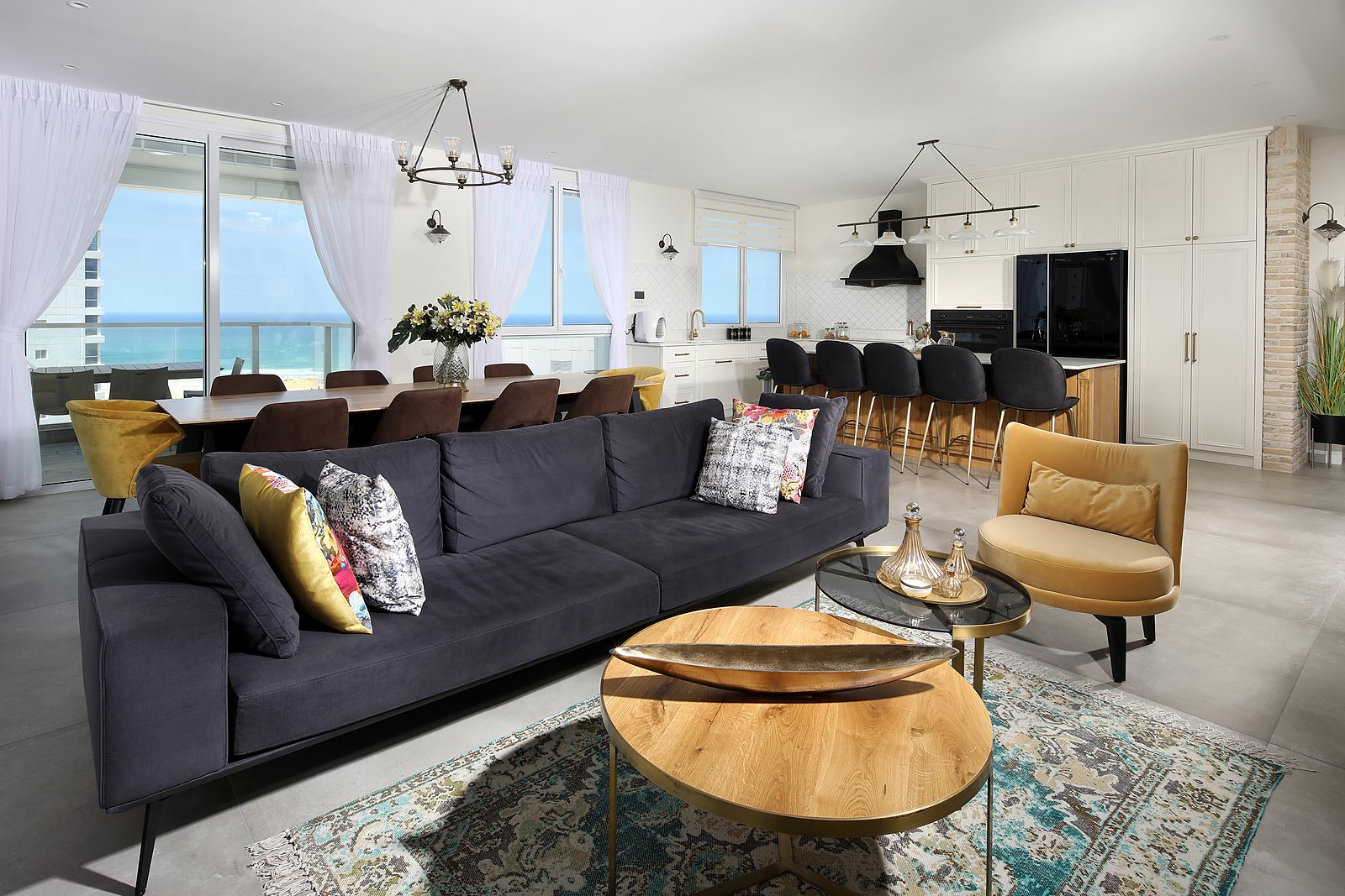 Open-plan living room and kitchen with a sea view
